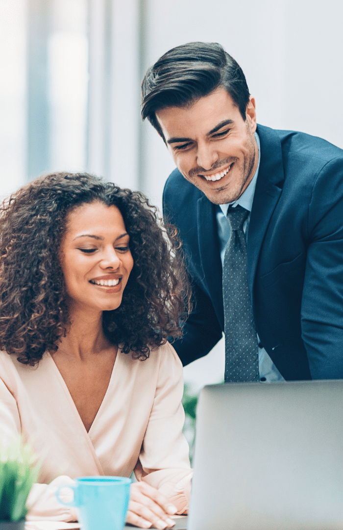 businesspeople smiling over a report as a positive outcome of business consulting services